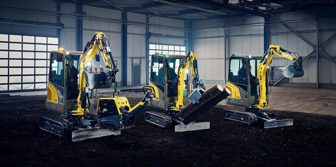 mini excavators in a row in industry hall