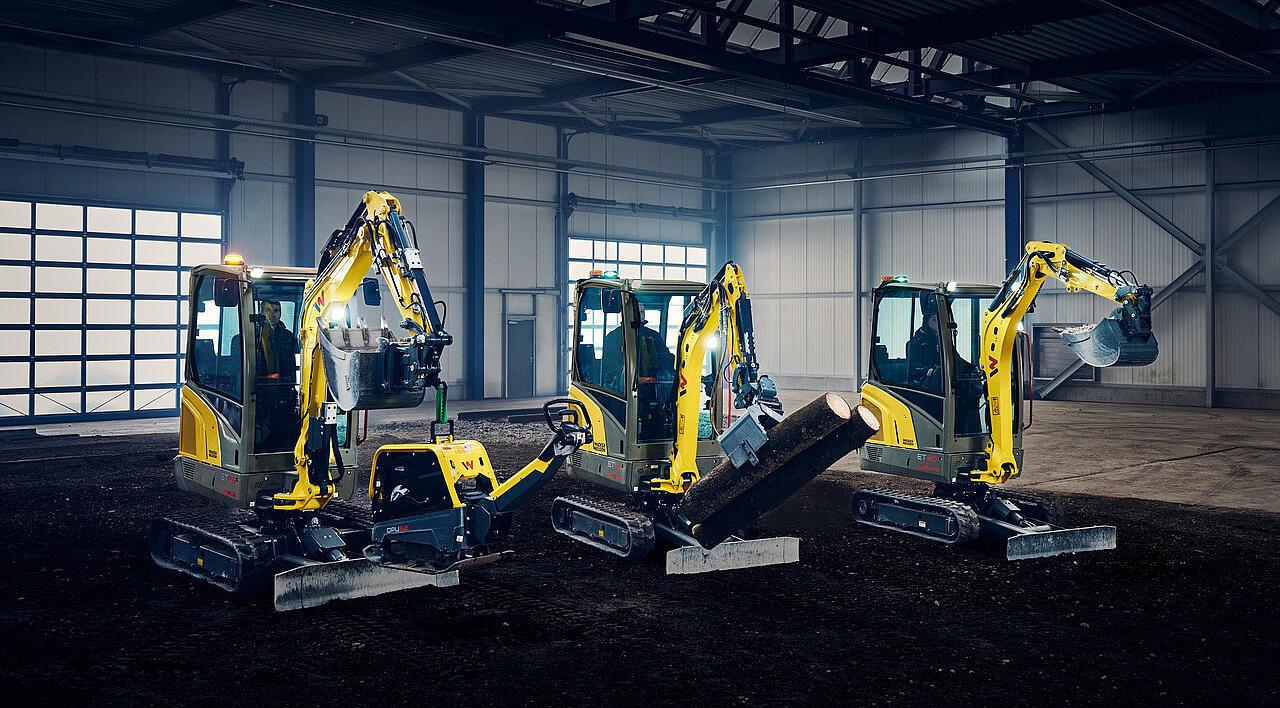 mini excavators in a row in industry hall