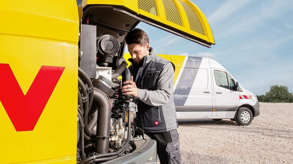 Wacker Neuson employee servicing a Wacker Neuson construction machine.