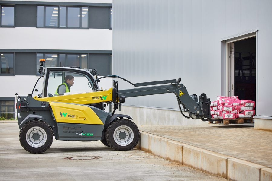 Wacker Neuson TH412e telehandler in use on a construction site with pallet fork