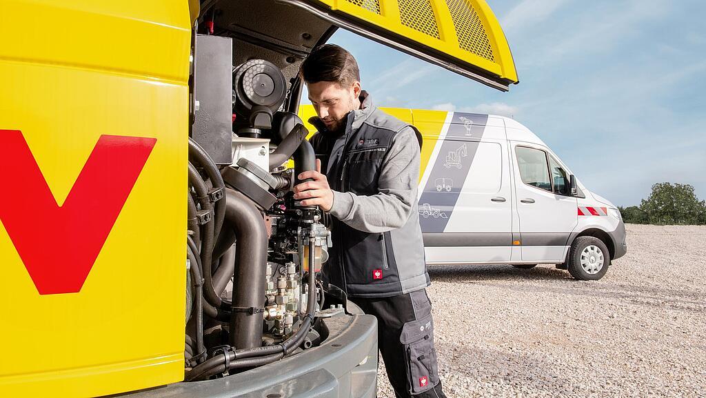 Wacker Neuson employee servicing a Wacker Neuson construction machine.