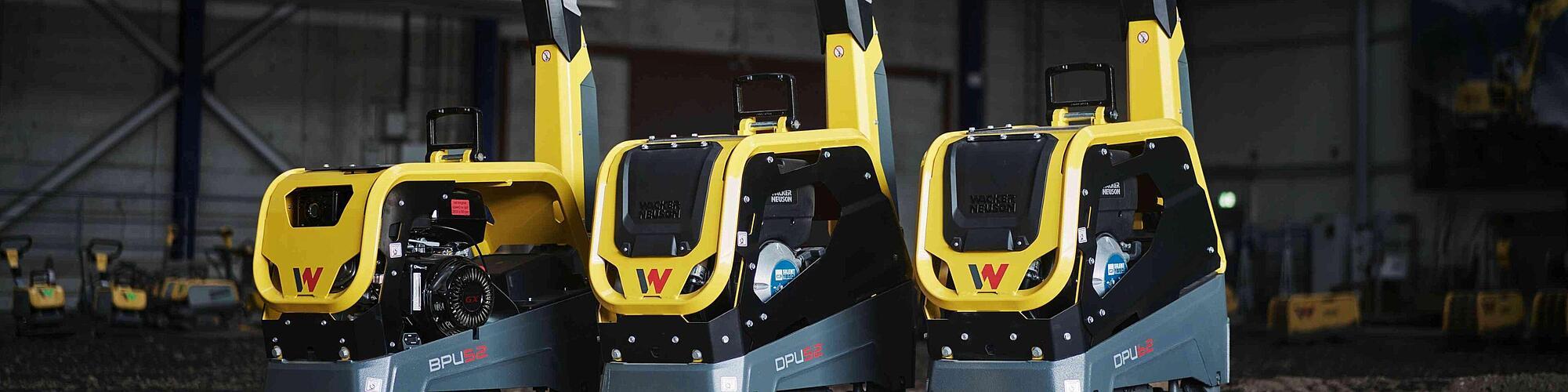 three vibratory plates standing in a row