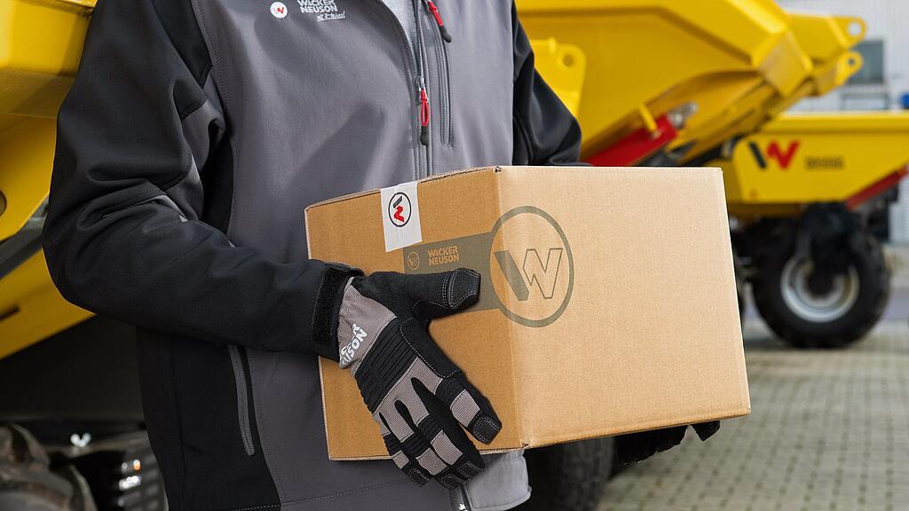 Wacker Neuson employee carrying Wacker Neuson repair package.