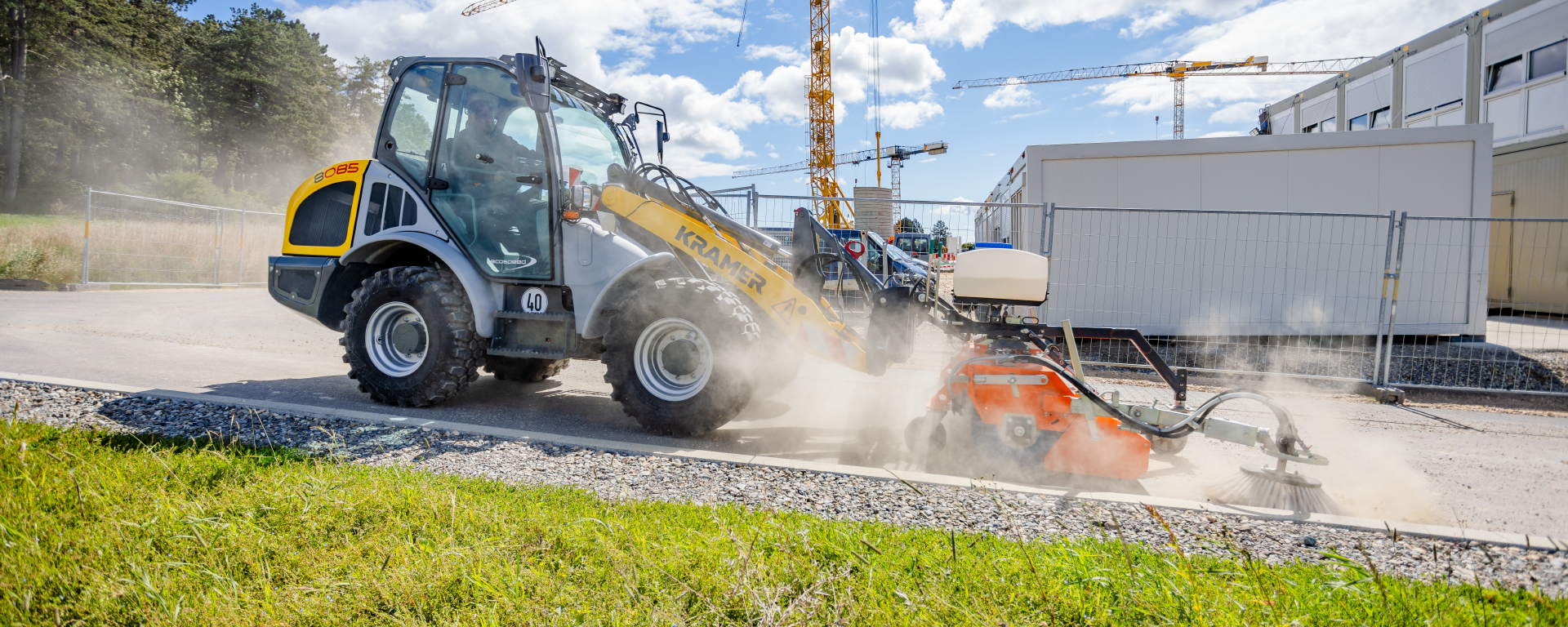 The Kramer wheel loader 8085 while cleaning a street.