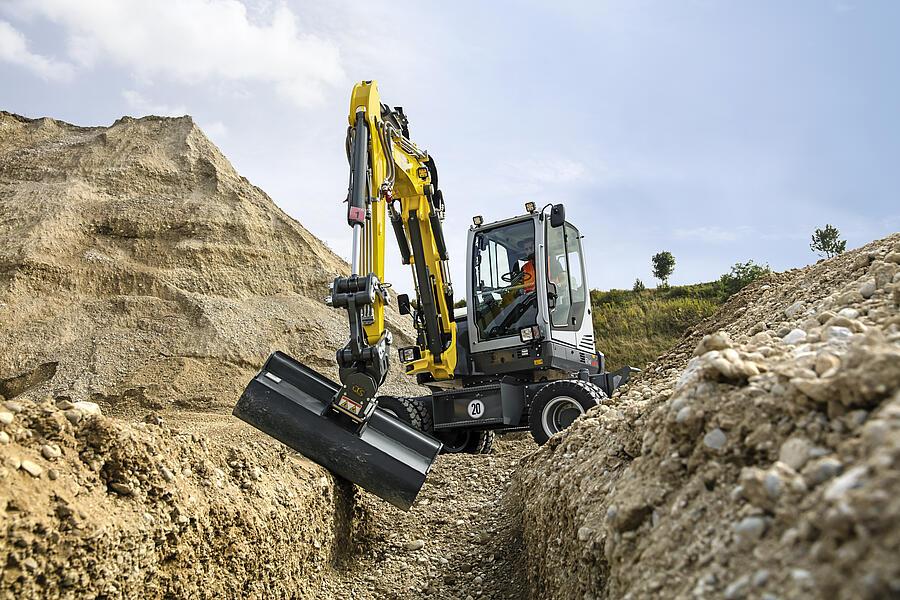 EW65 mobile excavator excavating a pipe trench in the filed