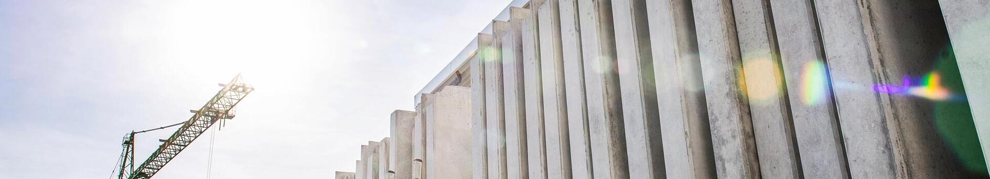 Concrete walls standing vertically on a construction site.