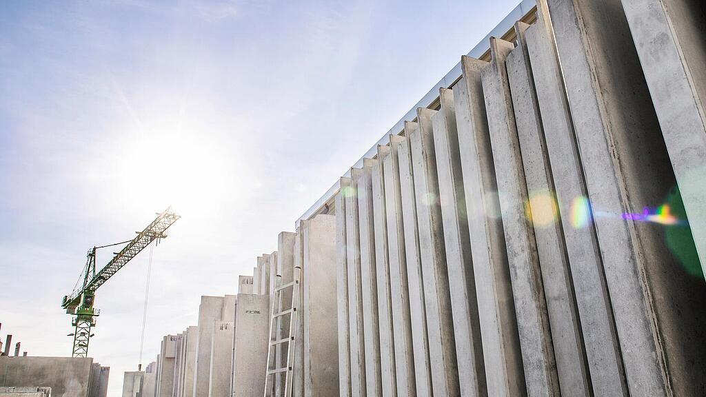 Concrete walls standing vertically on a construction site.