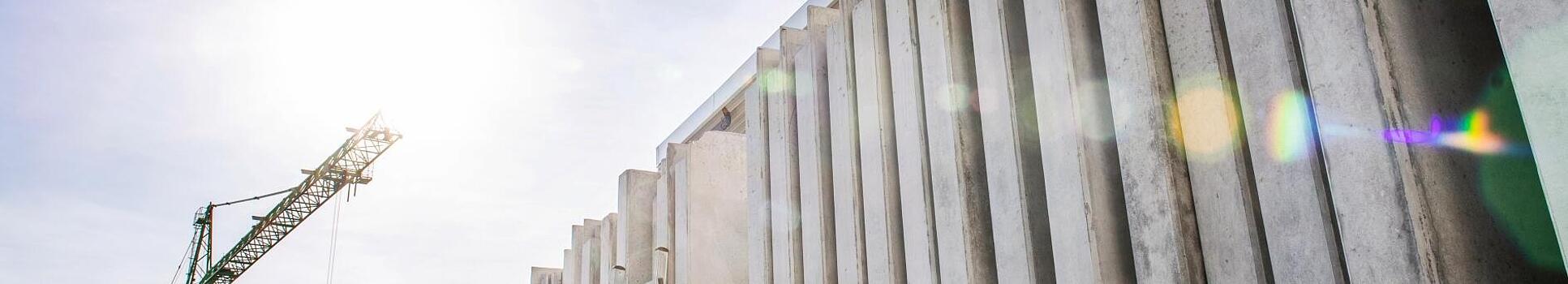 Concrete walls standing vertically on a construction site.