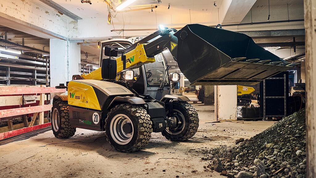 electric telehandler th412e working at construction site