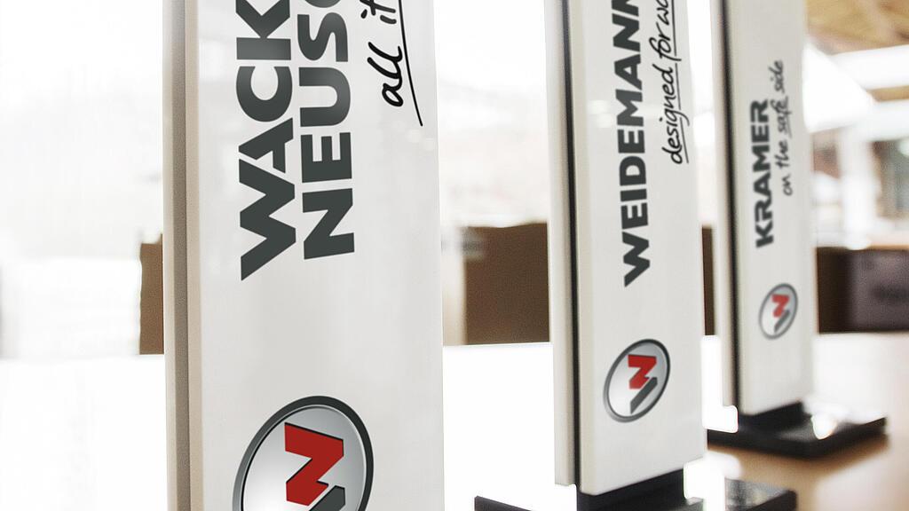 De drie merken van de Wacker Neuson Groip: Wacker Neuson, Weidemann en Kramer.