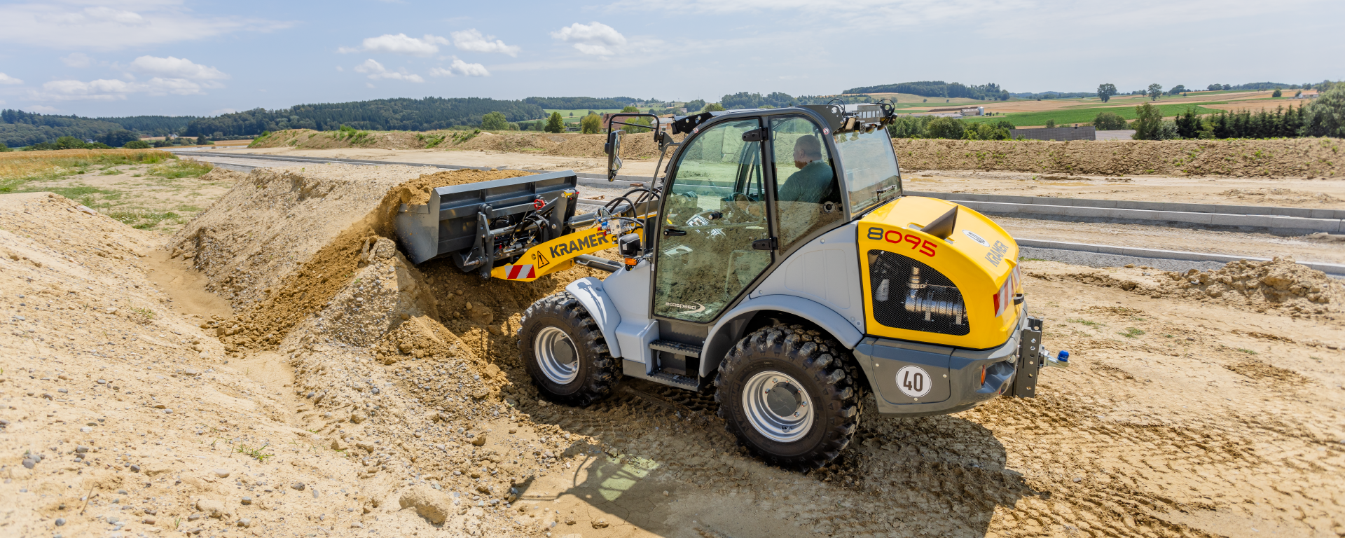 The Kramer wheel loader 8095 while working with soil.