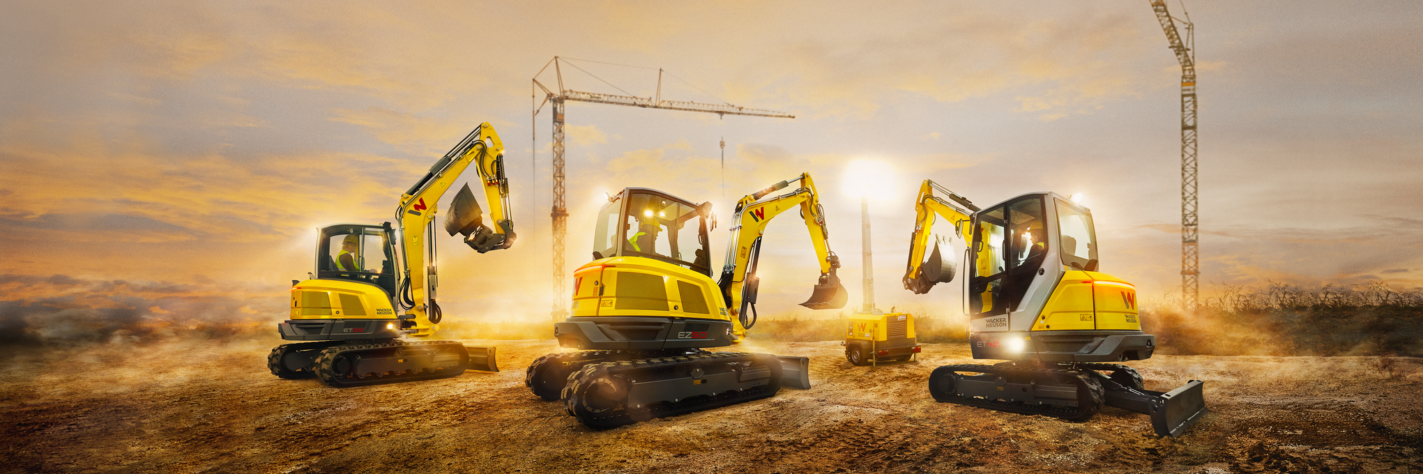 Wacker Neuson tracked excavator ET58 with other Wacker Neuson construction machines on a construction site at sunset.