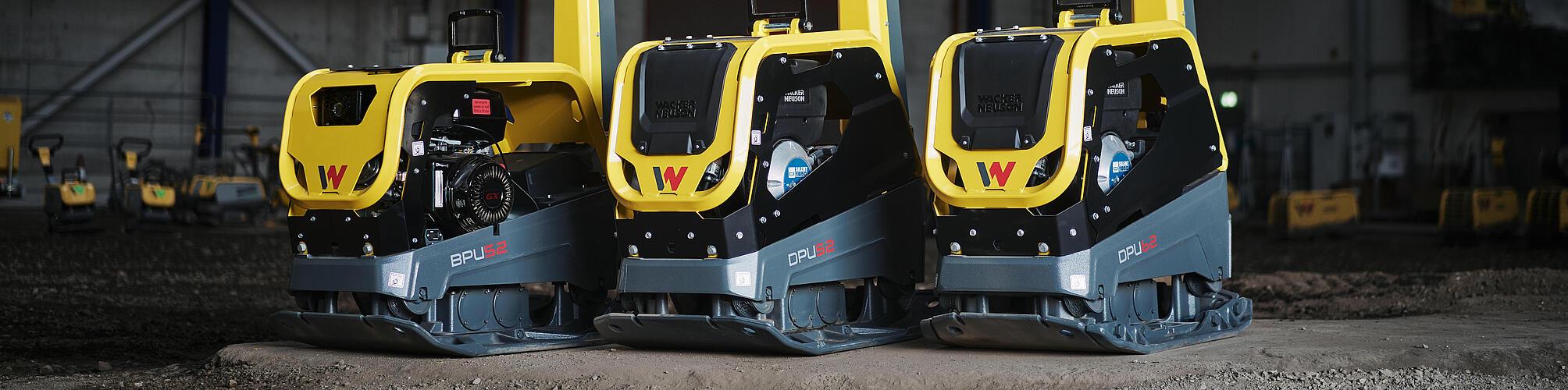 three vibratory plate standing in a row